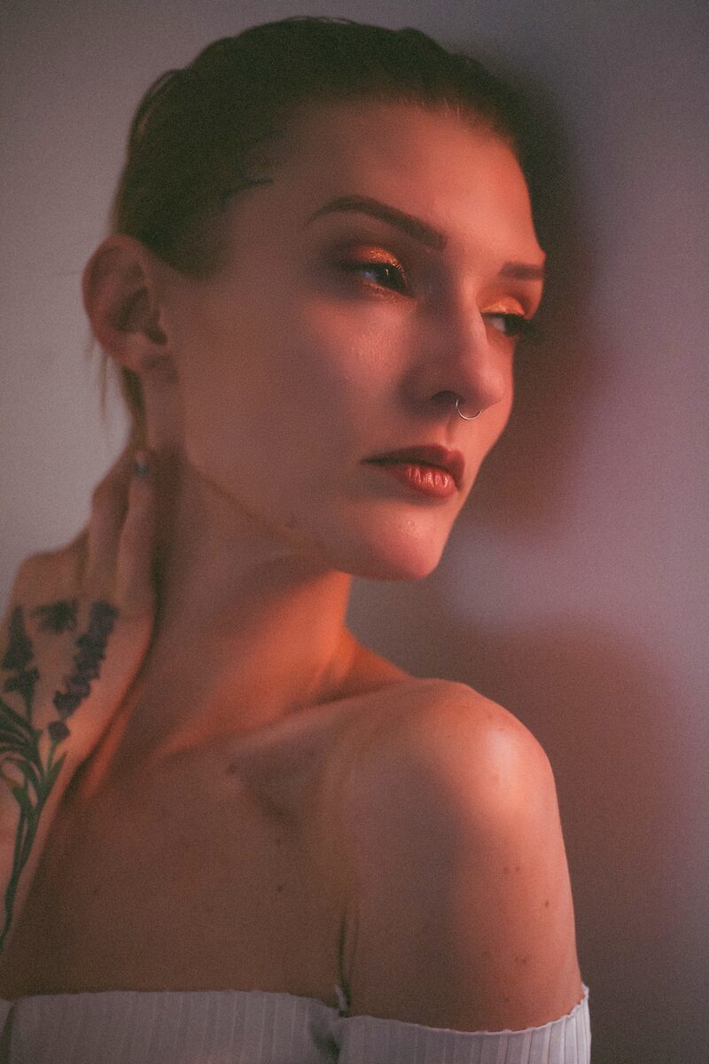 Portrait of a woman in soft window light, looking away from the camera
